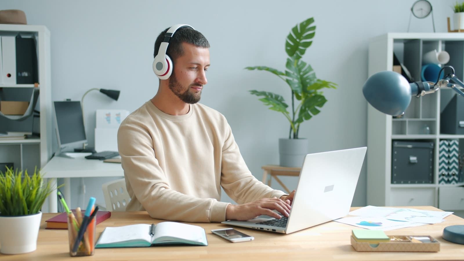 Person wearing headphones, listening to focus music while working