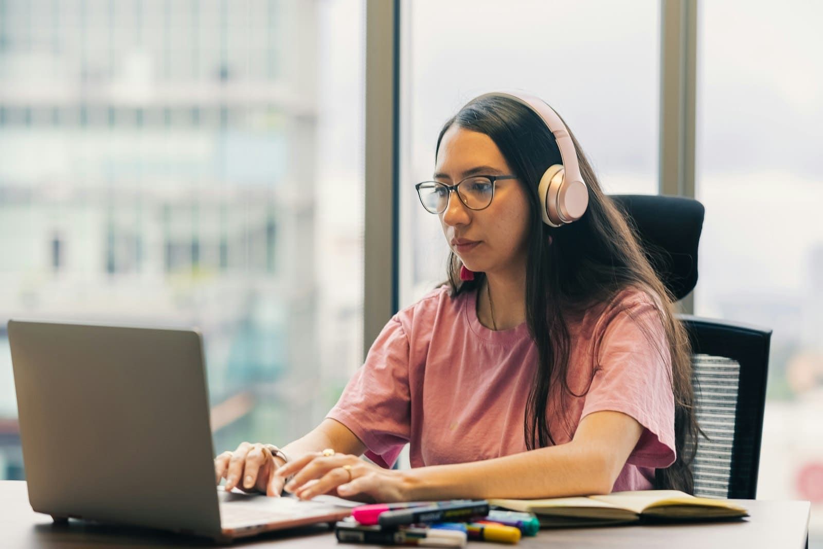 Person studying with headphones, deep in focus